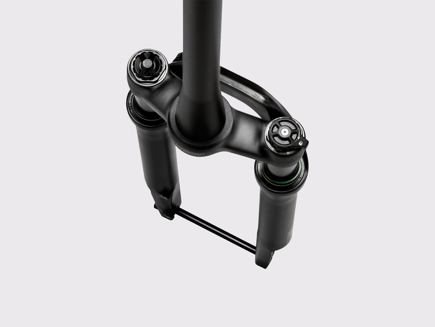 Vue supérieure du té de fourche montrant la valve de précharge d'air et la molette de commande de suspension intégrée.