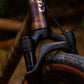 Vue latérale avant d'un vélo complet CYKL GRAAVE. Le cadre en aluminium anodisé violet "camo" avec lettrage GRAAVE est équipé de la fourche suspendue KS GTC de 40mm (arceau carbone visible, plongeurs 30mm). Poste de pilotage gravel, freins Flat Mount et pneu gravel volumineux. Passage externe de la durite de frein.