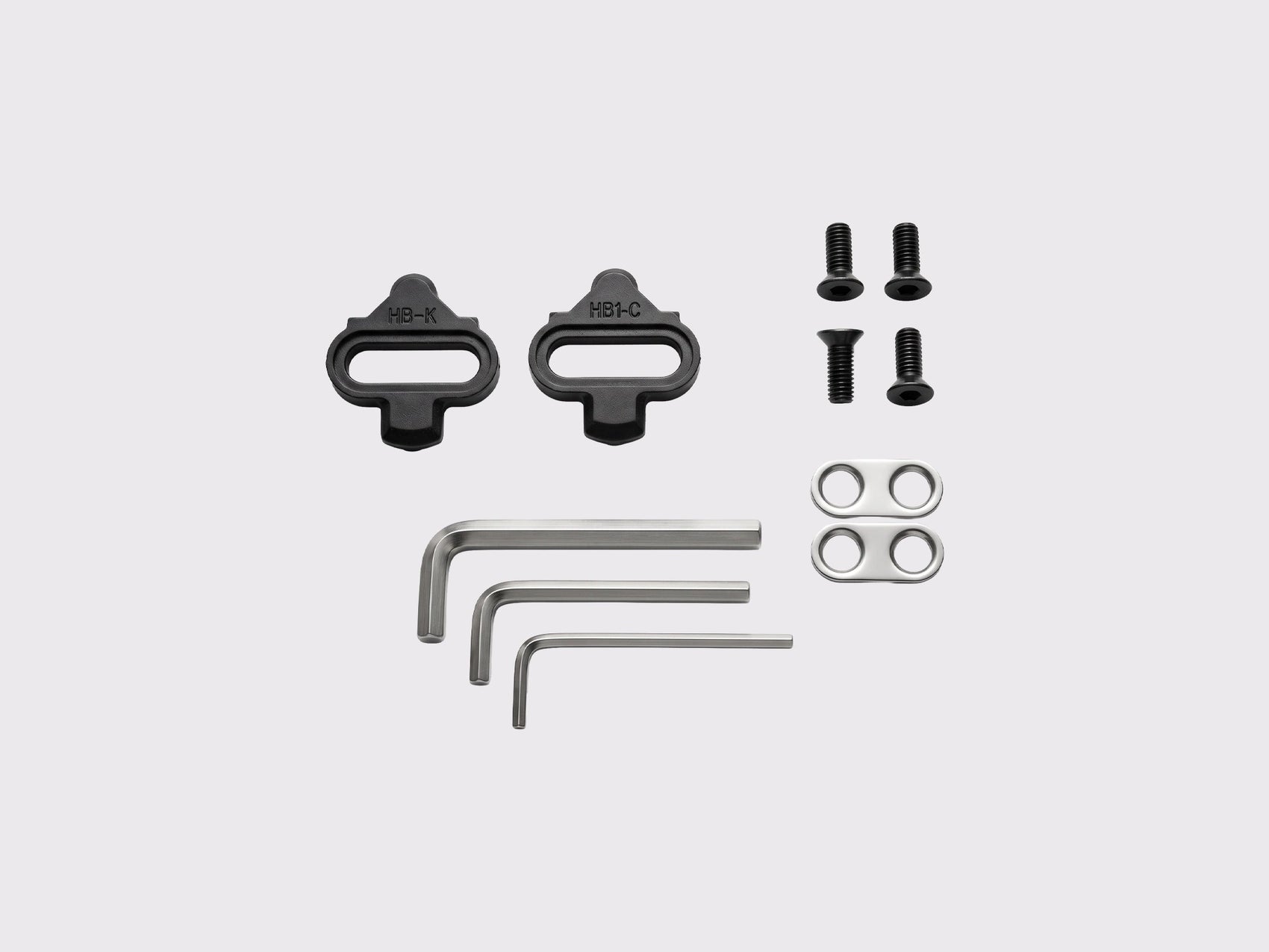 Contenu du pack Racework SPD-Plate comprenant les cales type SPD, la visserie de fixation et les clés Allen pour le montage et le réglage de tension.