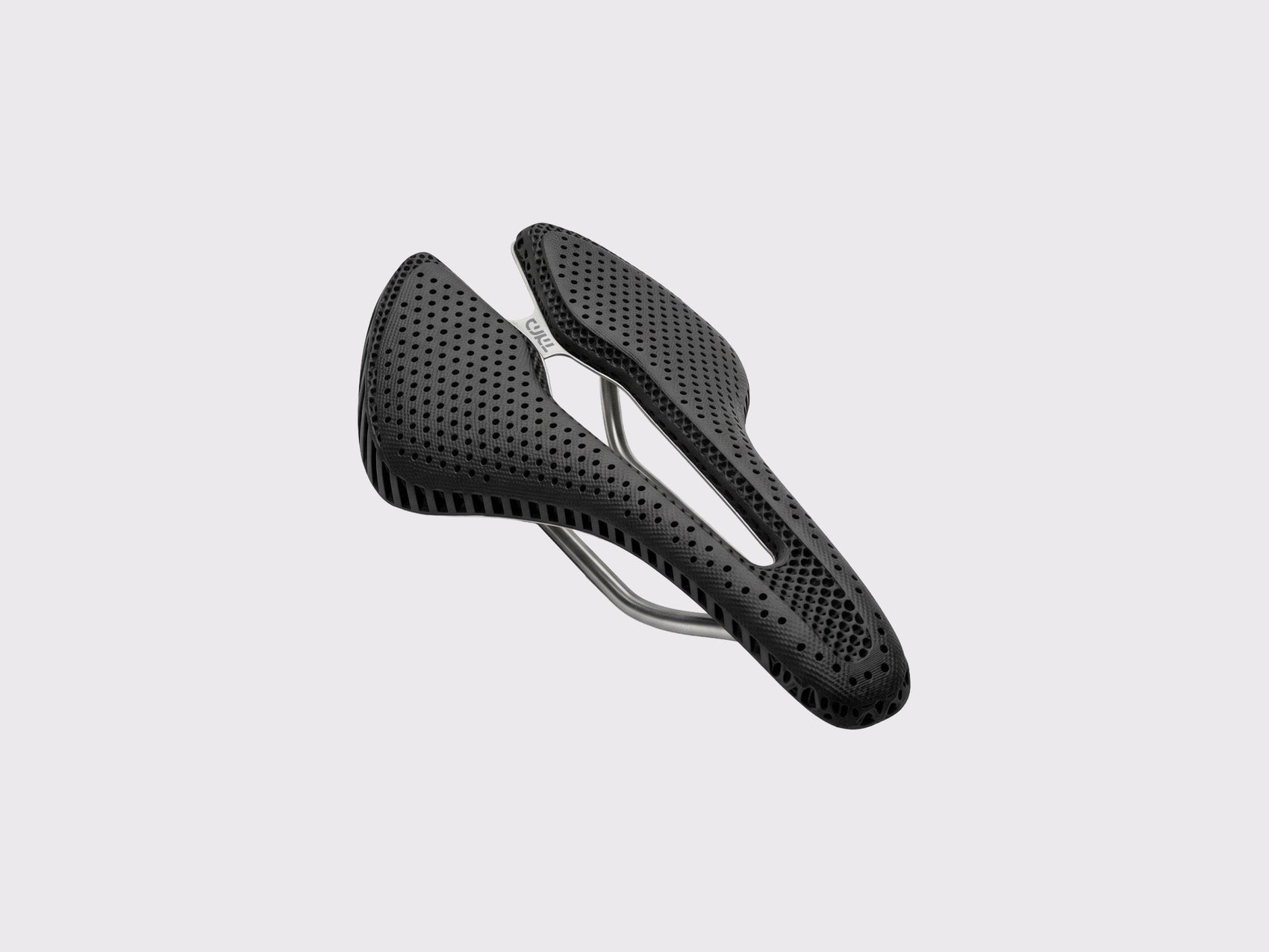 Selle Titane CYKL ERGO 3D Ti : vue perspective illustrant la structure alvéolaire en élastomère et l'optimisation topologique du châssis titane pour le flex dynamique.